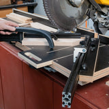 Easy Angle Miter Jig cutting wood on a miter saw in a woodworking shop