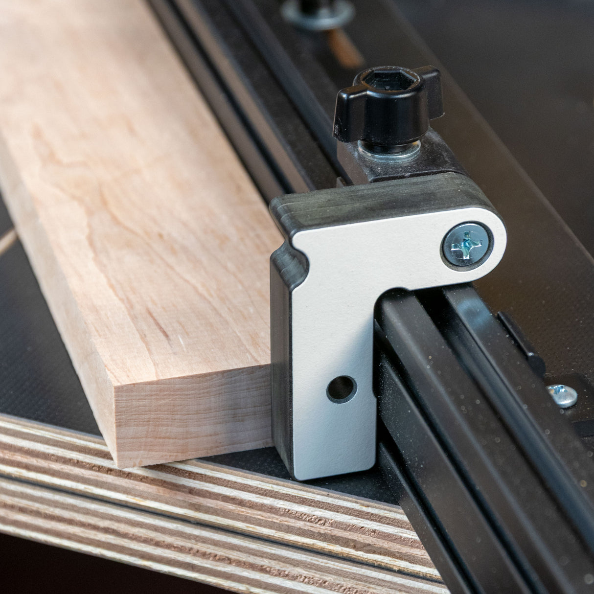 Easy Angle miter jig flip stop attached to a woodworking fence with a wood block