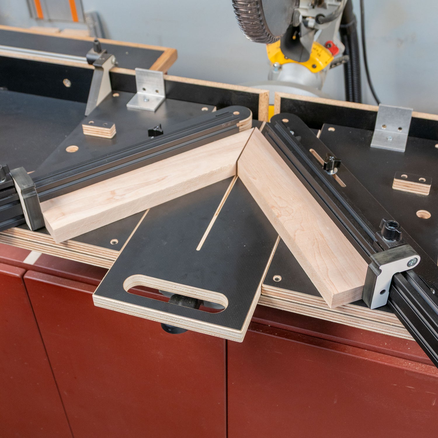 Easy Angle miter jig clamped to a saw station, holding wood pieces for precise miter cuts