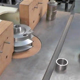 Woodworking shaper cutter head on table saw with wooden fence for precision joinery