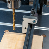 Drill press setup with precision fence stop and wood for accurate woodworking tasks