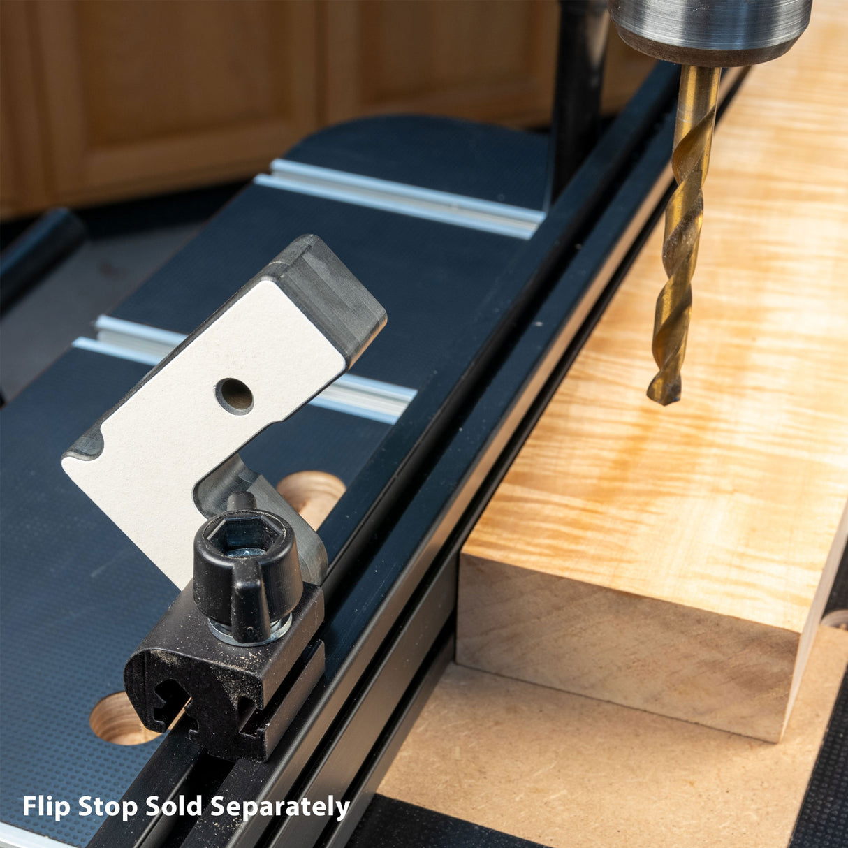 Drill press fence with flip stop and wood block setup, woodworking tool closeup