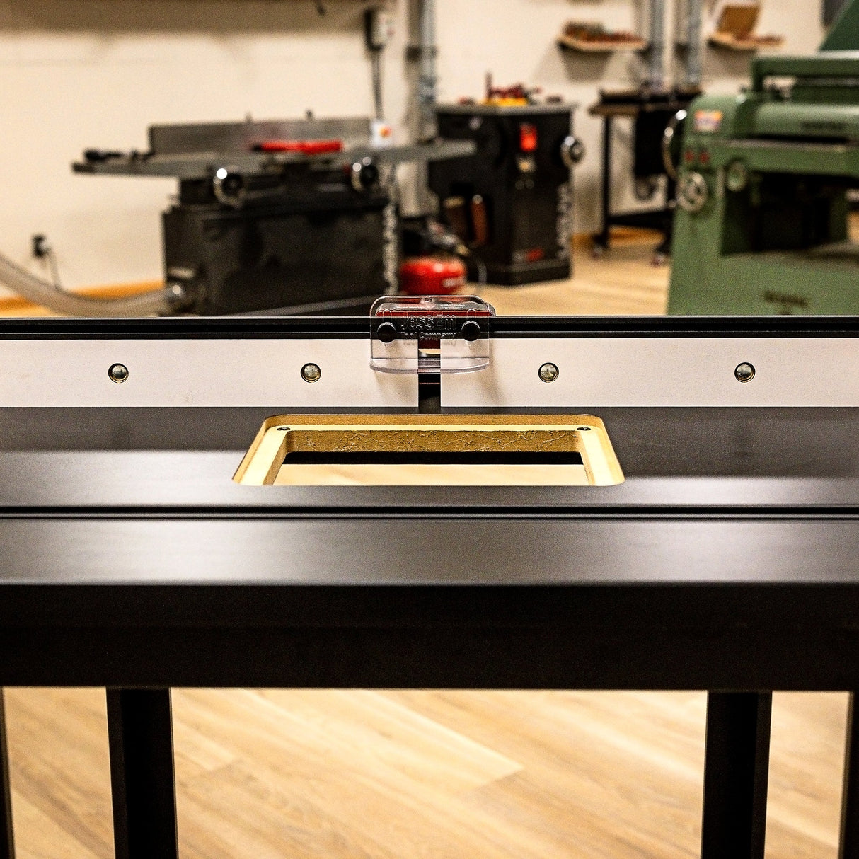 Router table with precision fence and insert plate in a woodworking workshop