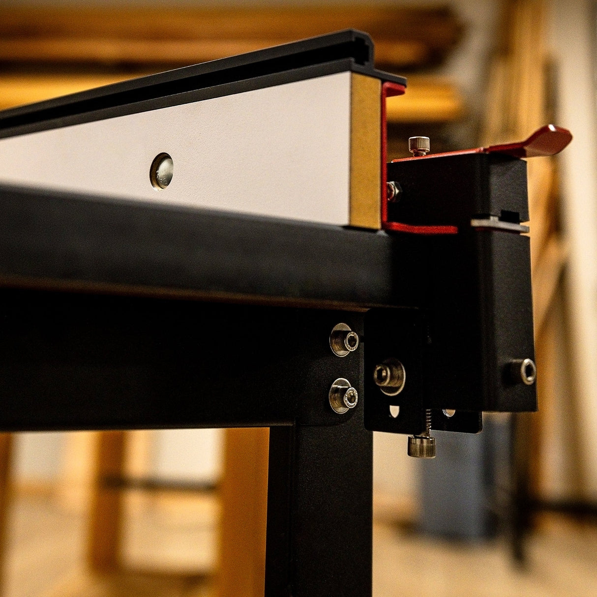 Close-up of adjustable router table fence for woodworking, showing hardware and locking mechanism