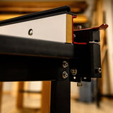 Close-up of adjustable router table fence for woodworking, showing hardware and locking mechanism