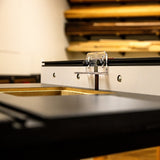 Router table fence with dust port and adjustable guard in woodworking shop setting