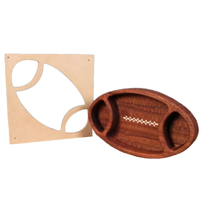 Wooden football-shaped serving tray with routed template on white background