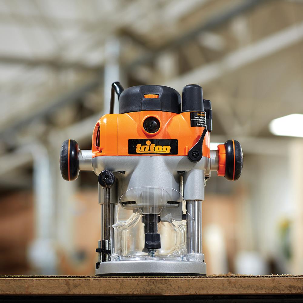 Triton plunge router on a workbench in a woodworking shop, close-up front view