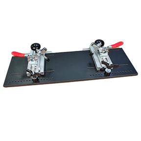 Woodworking jig with two adjustable clamps on a flat black board for precise cutting