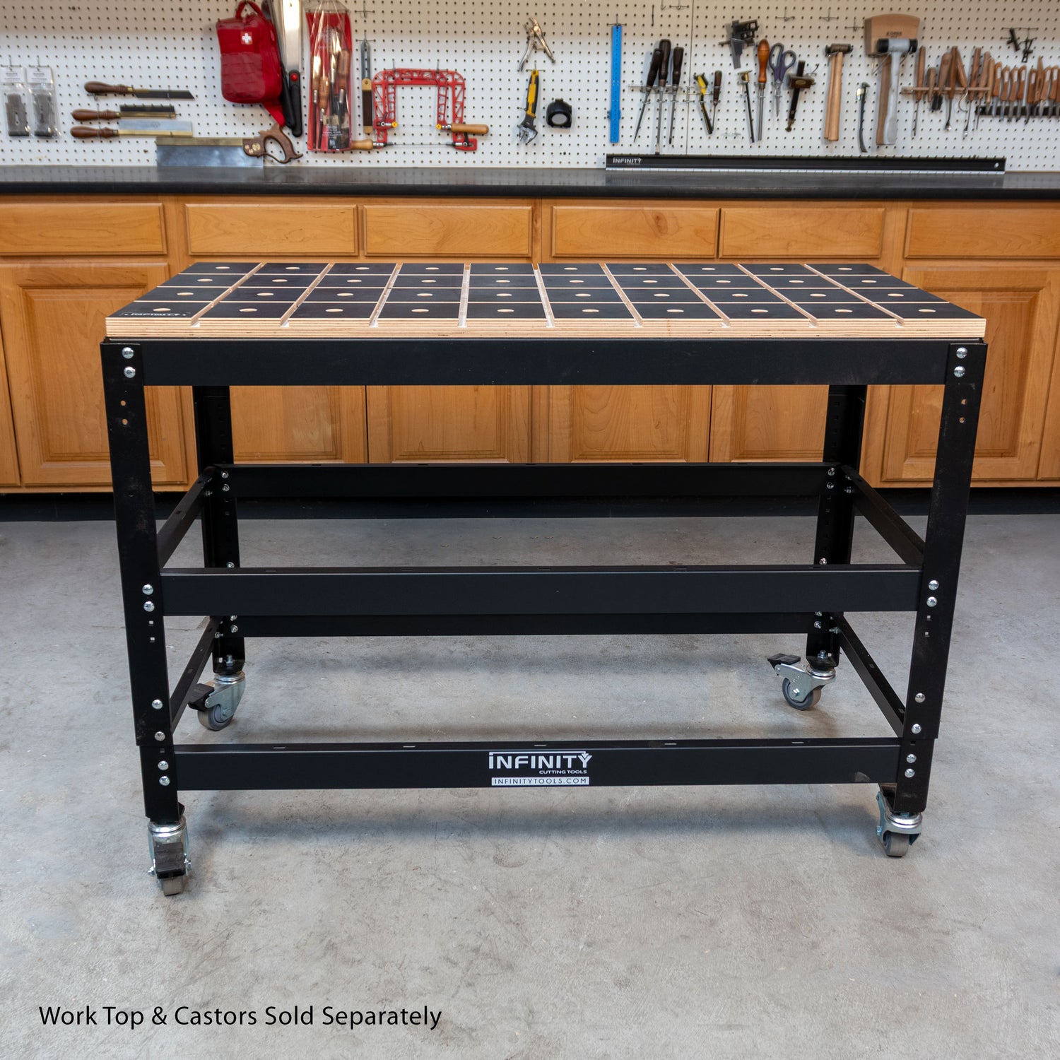 Black workbench with dog holes in a workshop setting