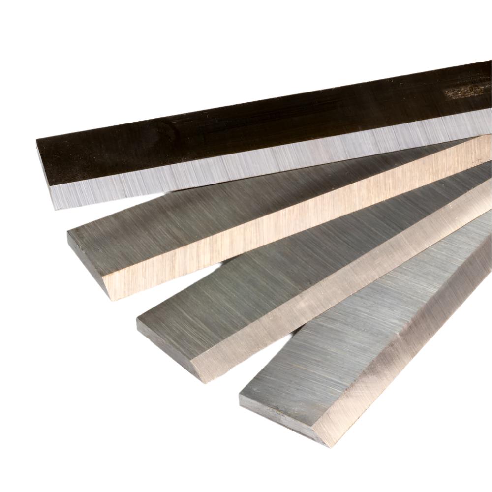 Set of four high-speed steel planer blades for woodworking, isolated on white background
