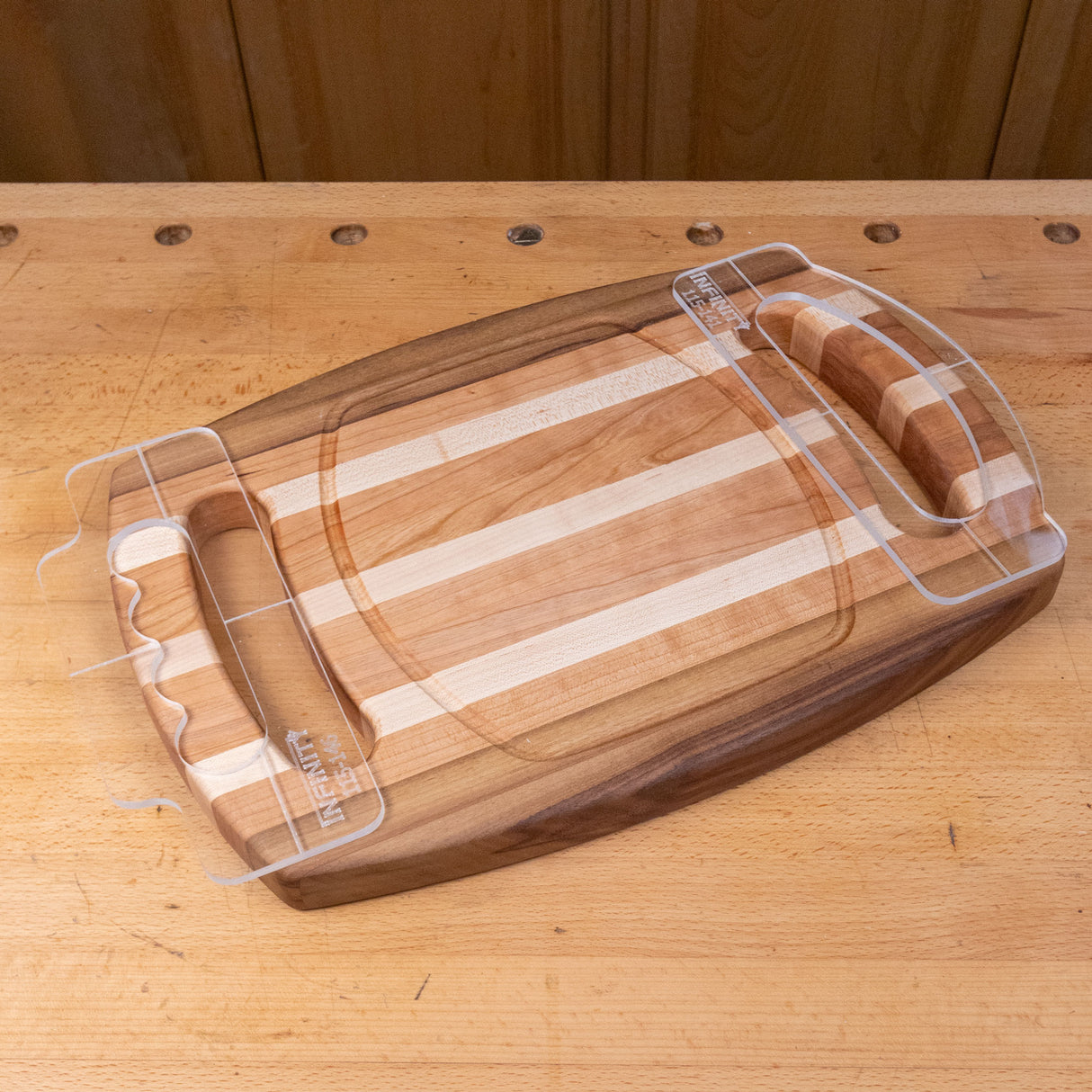 Wooden cutting board with finger groove handles on a workbench, woodworking tool accessory