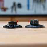 Two woodworking router table nuts side by side, showing height difference with red arrow