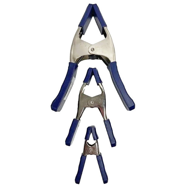 Set of three metal spring clamps with blue handles for woodworking projects