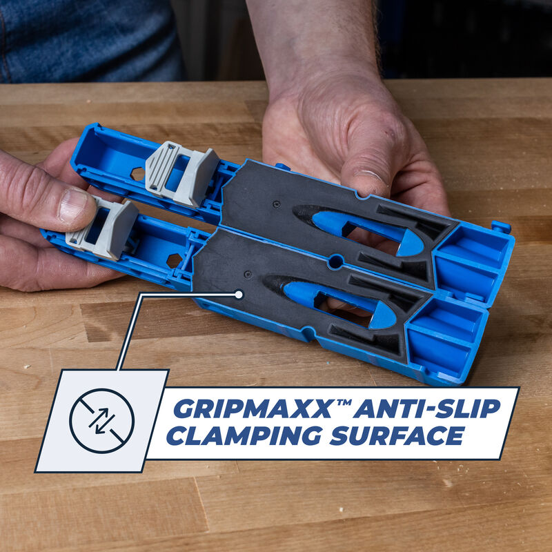 Hands holding a blue woodworking jig with GripMaxx anti-slip clamping surface on workbench