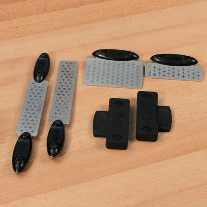Diamond sharpening stones and guides for woodworking, displayed on a wood workbench.