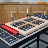 Woodworking workbench with clamps holding a wood frame in a workshop setting