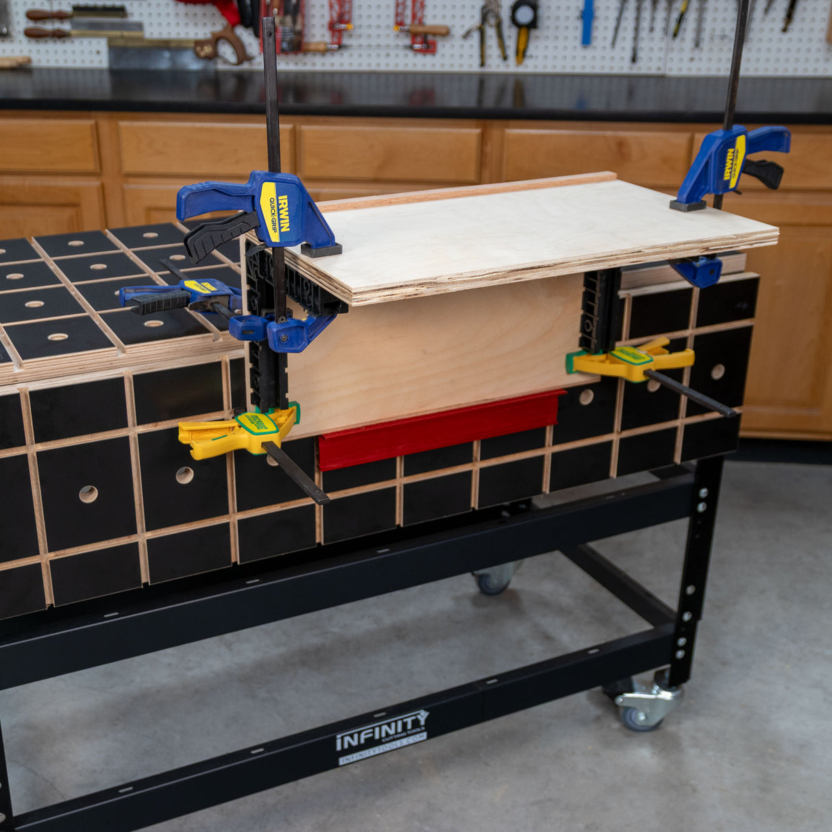 Woodworking MFT workbench with clamps securing plywood for precision clamping tasks