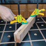 Hand clamping wood to a workbench with MicroJig quick-release woodworking clamps