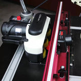Router table setup with precision router lift, fence, and motorized feed system for woodworking.