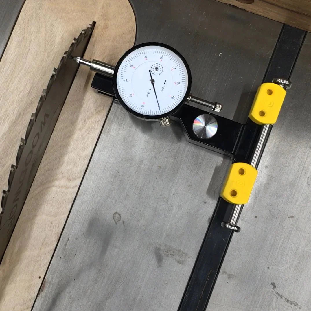 Miter slot indicator measuring saw blade alignment on a table saw surface