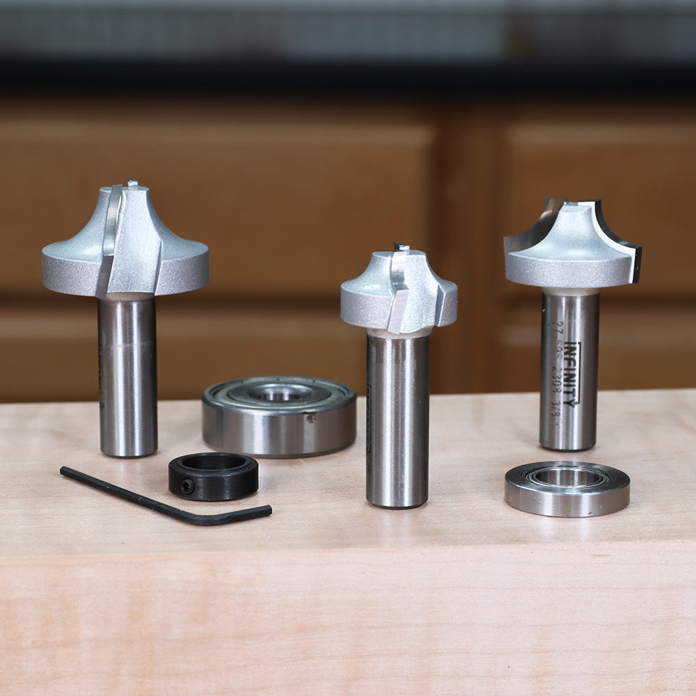 Woodworking router bits set with bearings and hex key on a workbench, ideal for precision cutting.