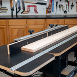 Router table extension fence with MDF faces and wood board in woodworking shop