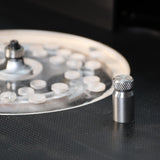 Router table setup with metal alignment pin and clear insert plate for woodworking precision