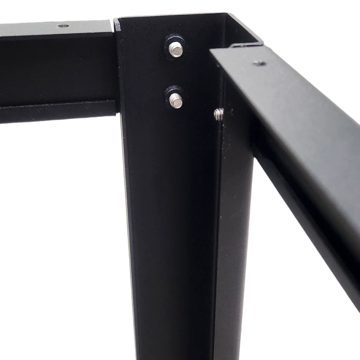 Close-up of black metal woodworking table frame corner with screws and joints