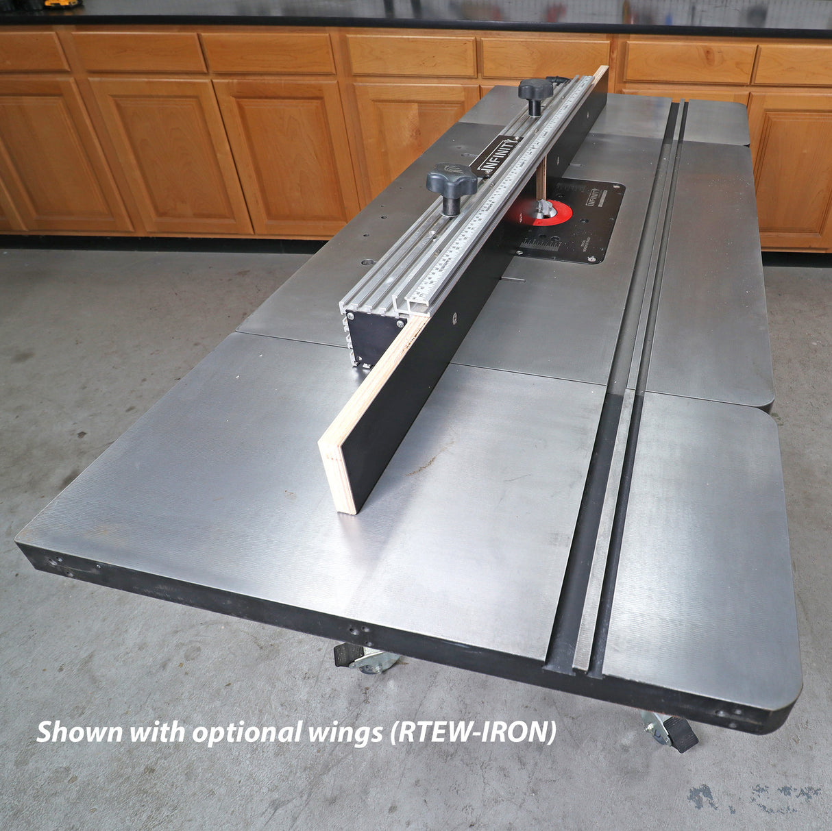 Cast iron router table with fence, ruler, and optional extension wings in workshop setting