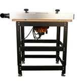 Back view of woodworking router table with metal legs, dust port, and mounted router.
