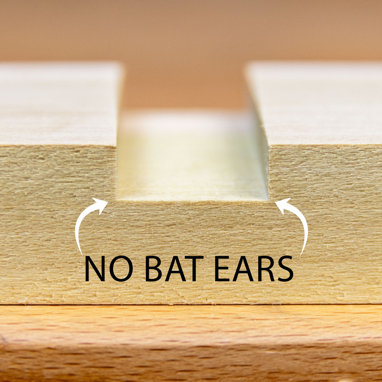 Cut from a stacked dado set with flat top blades resulting in no bat ears.