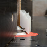 Router table with insert bit cutting joinery profile on wood, woodworking tool close-up