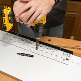 Using a drill and shelf pin jig to create evenly spaced holes in a woodworking project