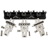 Precision woodworking doweling jig set with metal guides and wall-mounted holder.
