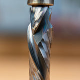Close-up of a spiral compression router bit with bearing for woodworking