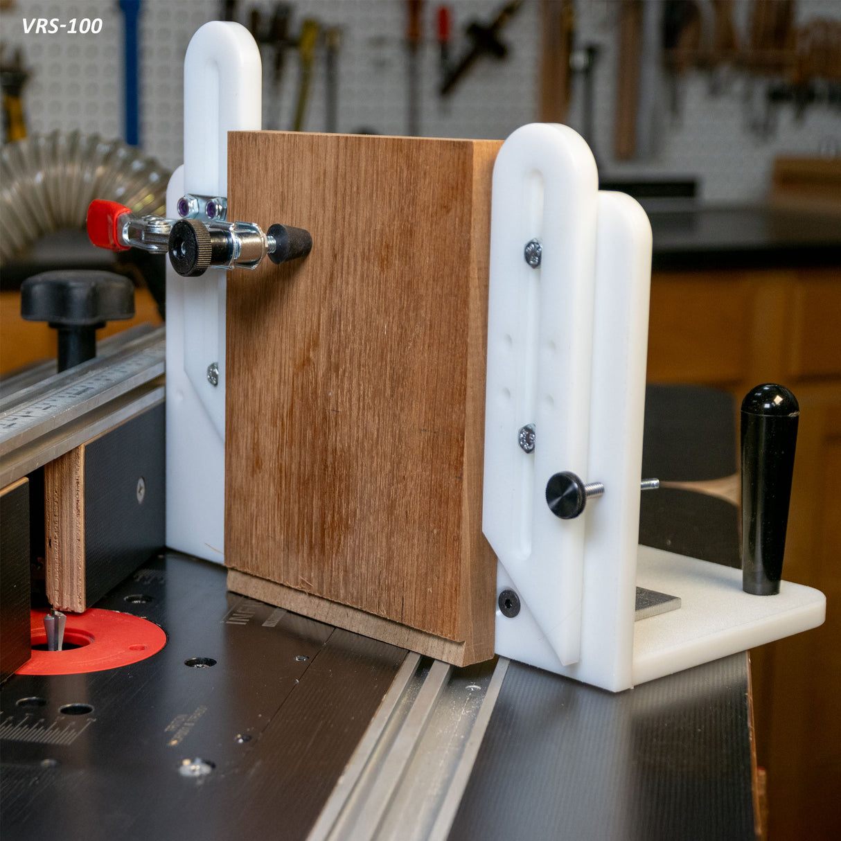 Vertical router sled jig holding wood upright on router table in woodworking shop