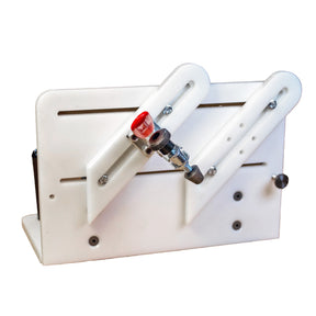 White woodworking sharpening jig with adjustable guides and red-handled clamp for precision grinding.