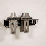 Wall-mounted woodworking dowel jig system with metal components and measurement guides.