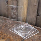 Clear acrylic diamond-shaped woodworking templates on a rustic wooden table
