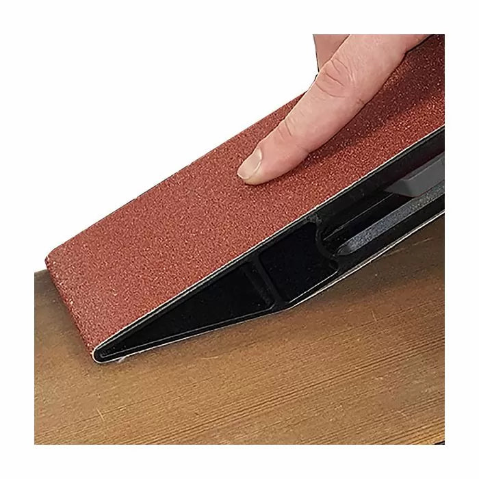 Hand using a sanding block to smooth a wooden surface, woodworking tool in action