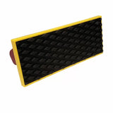 Rectangular hand sanding block with black textured grip and yellow border, woodworking tool
