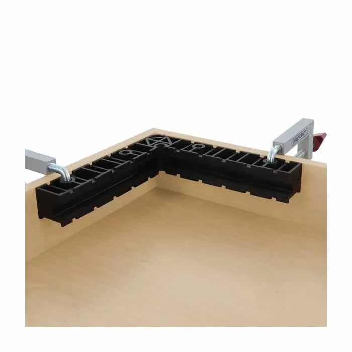 Woodworking corner clamp jig securing two wooden boards at a right angle for precise assembly