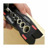 Drill guide block used for precise wood drilling, showing multiple hole sizes and a hand-held drill.