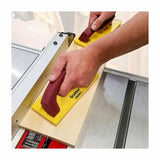 Woodworker using push blocks to guide wood on a table saw for safe, precise cutting.