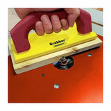 Push block guiding wood on a router table for safe woodworking operations