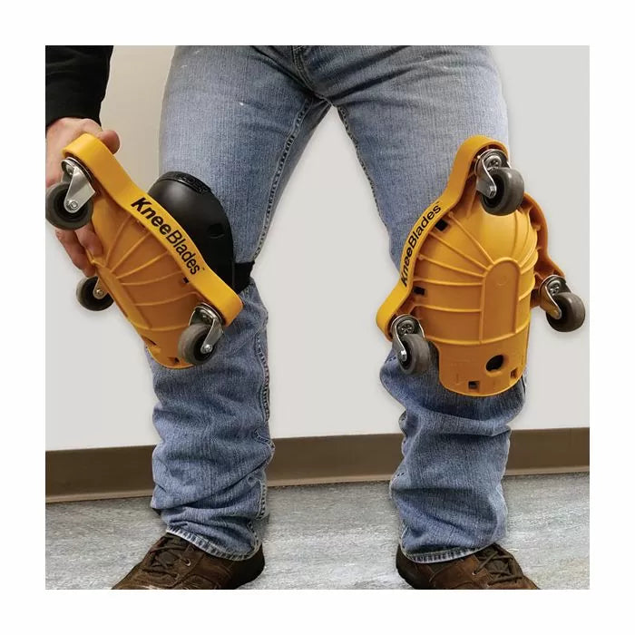 Yellow KneeBlades knee pads with wheels worn over jeans for easy movement on flooring projects