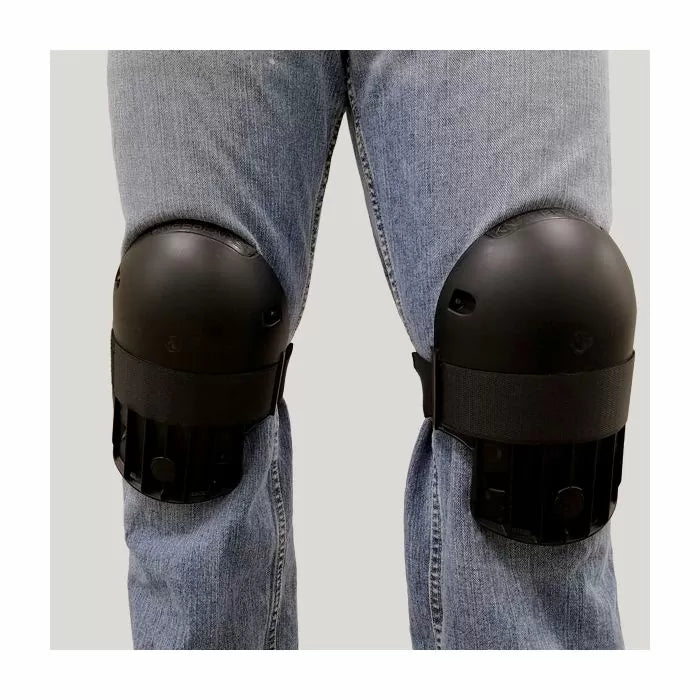 Black protective knee pads worn over jeans for woodworking or construction safety