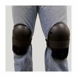 Black protective knee pads worn over jeans for woodworking or construction safety