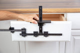 Cabinet hardware jig used to measure and mark drawer front for woodworking installation